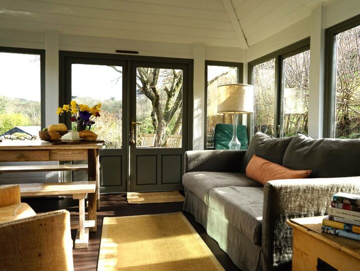 Porth Nanven Cottage dining area with patio doors to garden in background