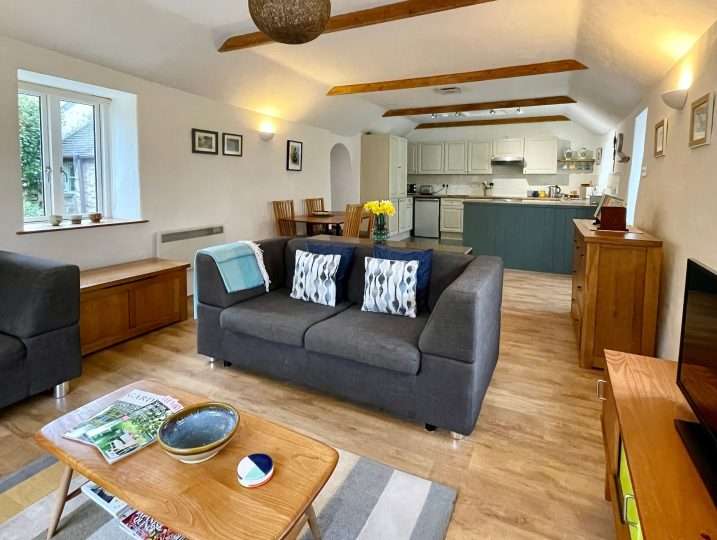 Cornish Barn Near Coast | Spacious sitting area with kitchen in background
